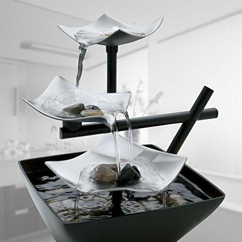 Decorative tabletop water fountain with cascading bowls and stones.
